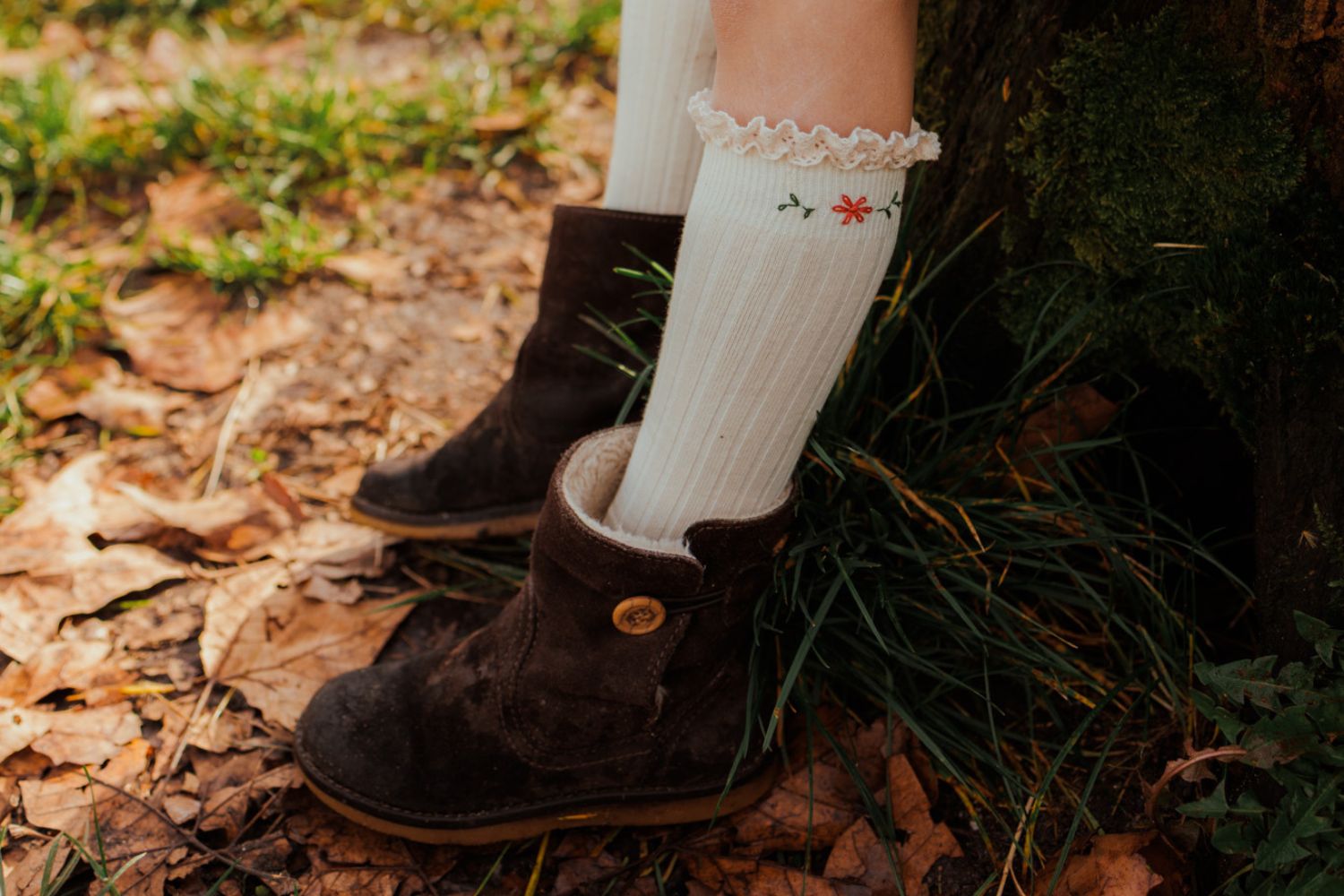 Cette photo montre des chaussettes brodées hautes, portées. Elles sont faite par l'atelier Magalu en gironde.